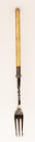 A rare plated metal pickle fork with a bone handle.