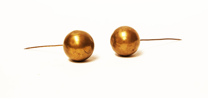 A set of brass head decorations from the traditional catholic dress of Zuid-Beveland. 