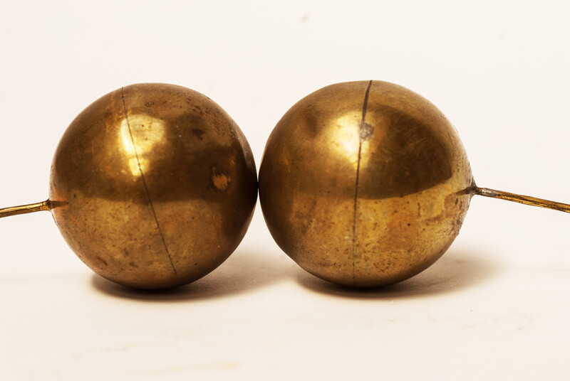 A set of brass head decorations from the traditional catholic dress of Zuid-Beveland. 