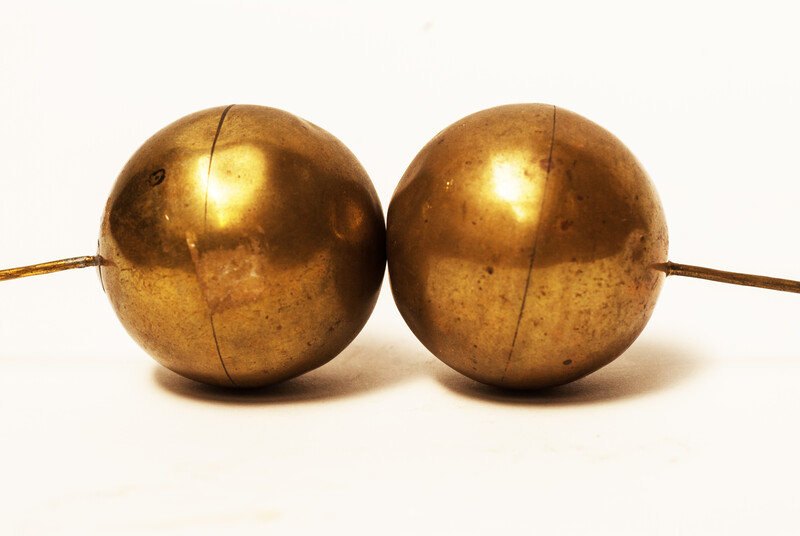 A set of brass head decorations from the traditional catholic dress of Zuid-Beveland. 