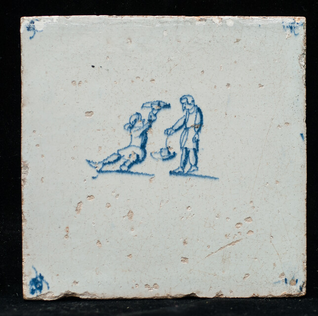 A seventeenth century Delft blue tile with two boys playing with their hats.