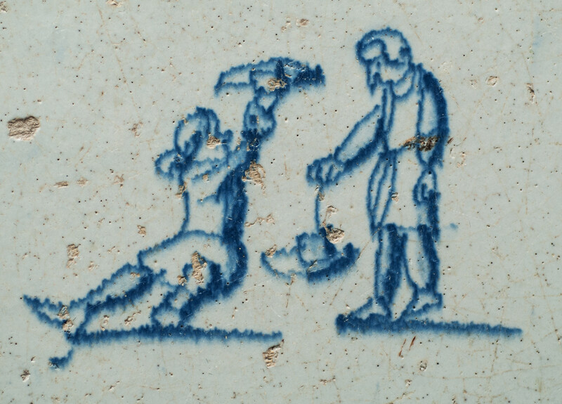 A seventeenth century Delft blue tile with two boys playing with their hats.