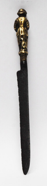 A seventeenth century Dutch knife with a brass handle showing a hunter and his dog.
