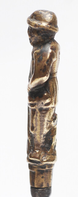 A seventeenth century Dutch knife with a brass handle showing a hunter and his dog.