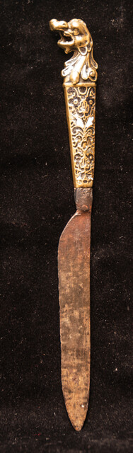 A sixteenth century European knife with a brass handle and enamel decorations.