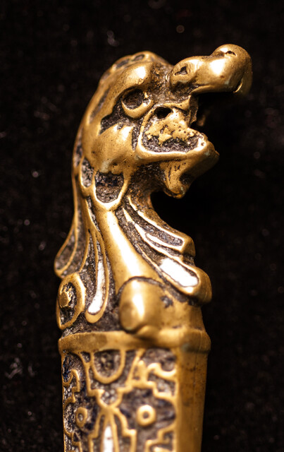 A sixteenth century European knife with a brass handle and enamel decorations.