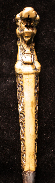 A sixteenth century European knife with a brass handle and enamel decorations.