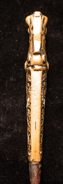 A sixteenth century European knife with a brass handle and enamel decorations.