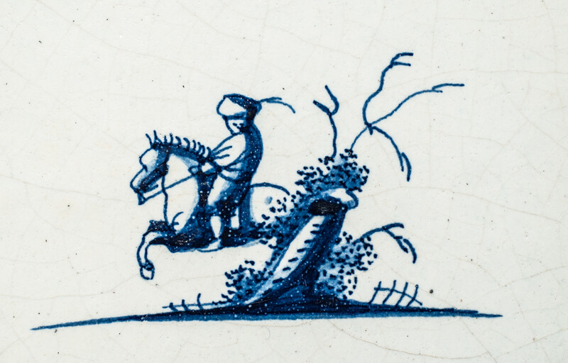 A small 17th C. Delft blue tile with a man on a horse.