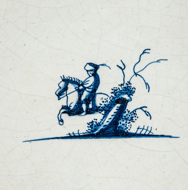 A small 17th C. Delft blue tile with a man on a horse.