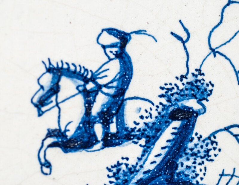 A small 17th C. Delft blue tile with a man on a horse.