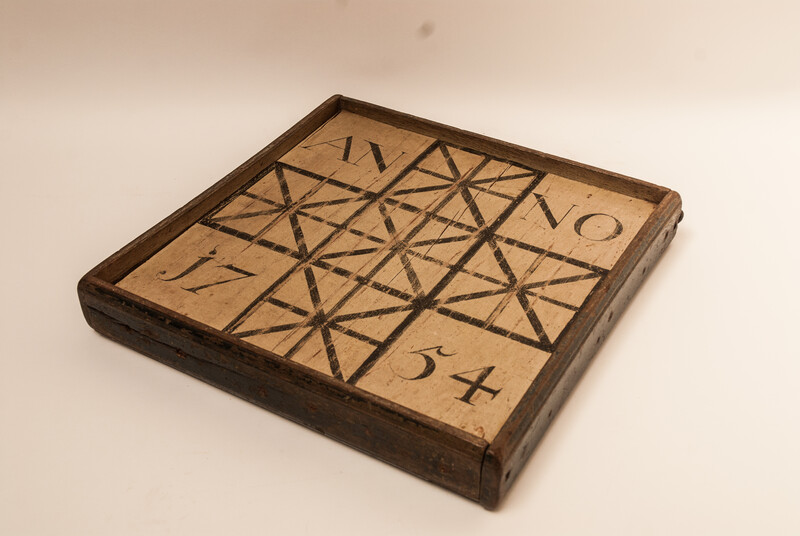 A unique Dutch painted draughtboard and a Fox and Geese game dated 1754, with a complete set of draughts in a fitted box.