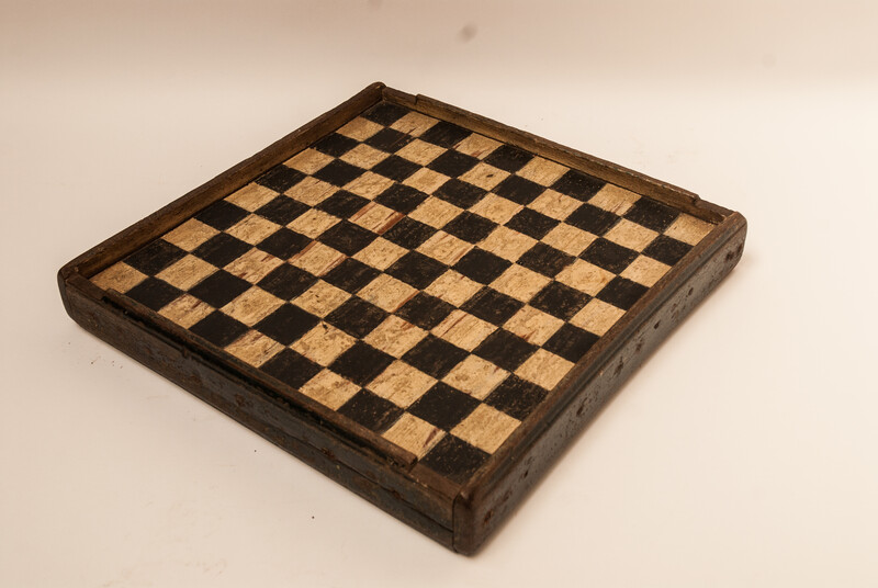 A unique Dutch painted draughtboard and a Fox and Geese game dated 1754, with a complete set of draughts in a fitted box.