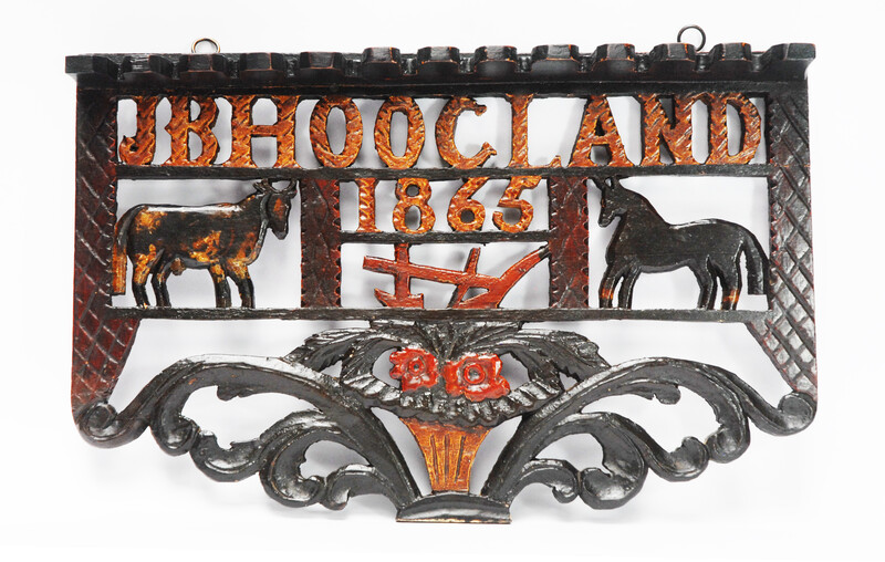 A wooden painted piperack dated 1865.