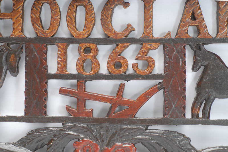 A wooden painted piperack dated 1865.