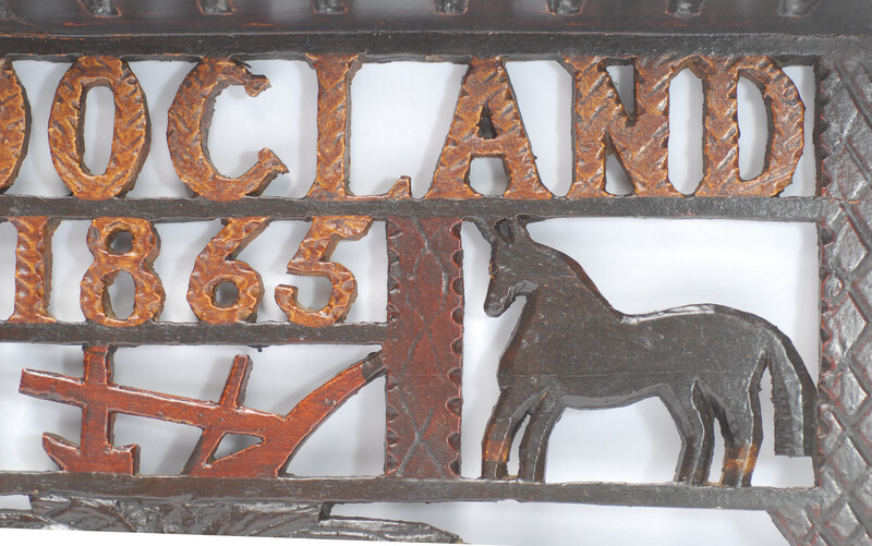 A wooden painted piperack dated 1865.
