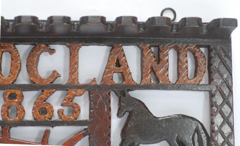 A wooden painted piperack dated 1865.