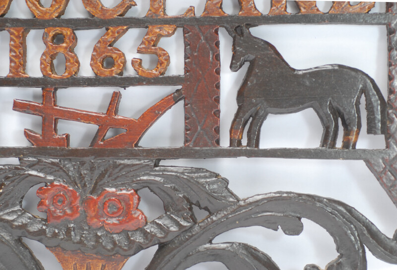 A wooden painted piperack dated 1865.