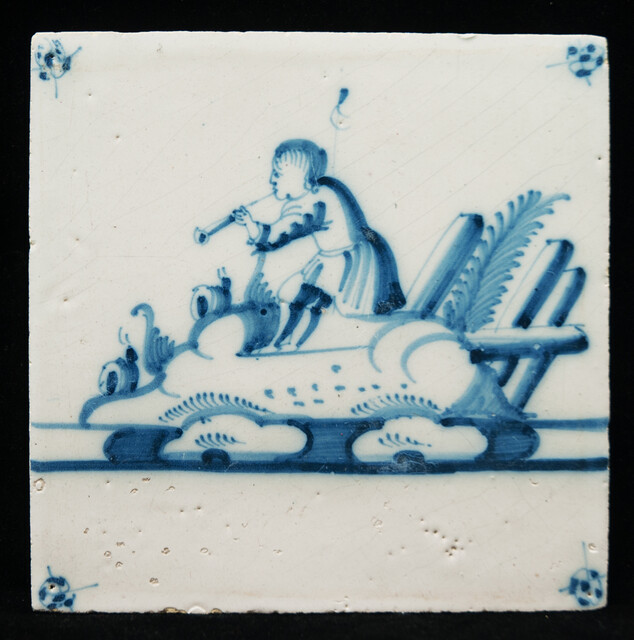 An 18th C. Delft blue tile with a hobo player.