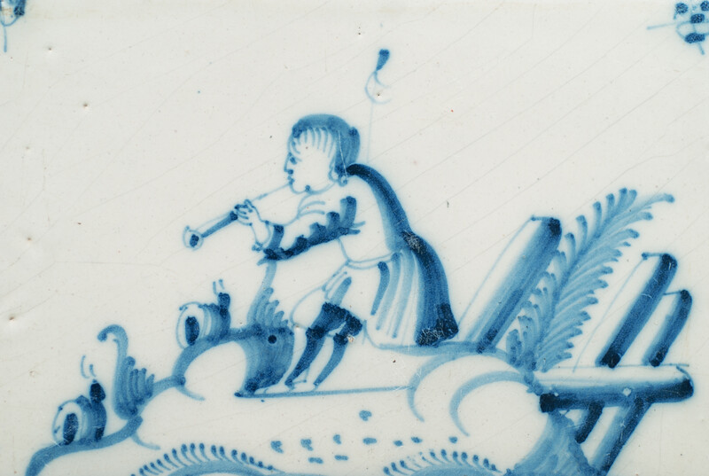 An 18th C. Delft blue tile with a hobo player.