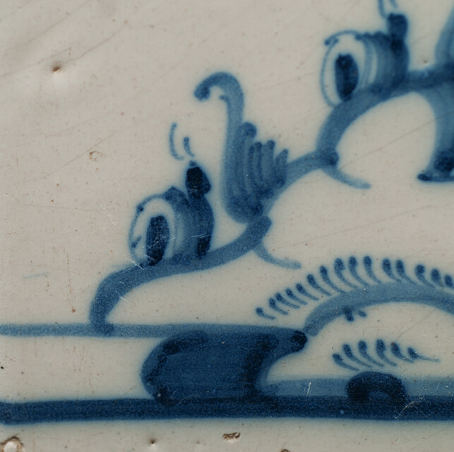 An 18th C. Delft blue tile with a hobo player.