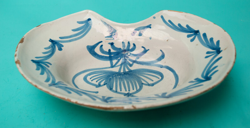 An 18th C earthenware shaving bowl made in Nevers.