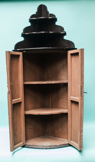 An 18th C. hanging corner cabinet from Ameland painted with a scene of King Solomon on his lion throne.