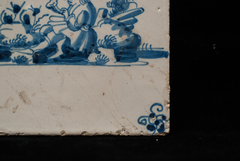 An 18th century Delft blue tile of a shepherd playing a shawm.