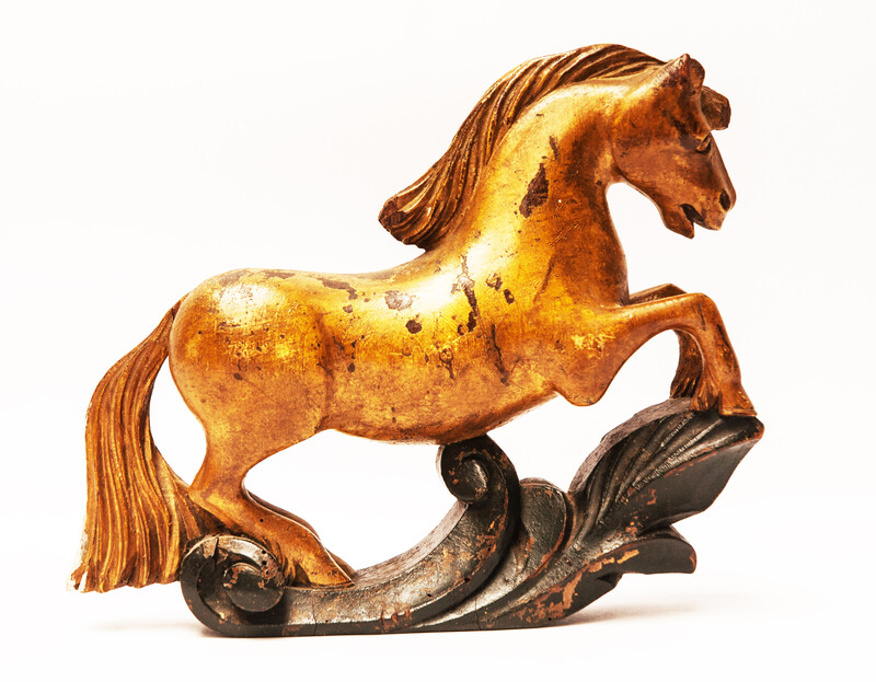 An 18th century Frisian wood carved and gilt rudder decoration in the form of a horse.