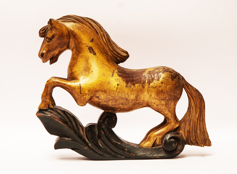An 18th century Frisian wood carved and gilt rudder decoration in the form of a horse.
