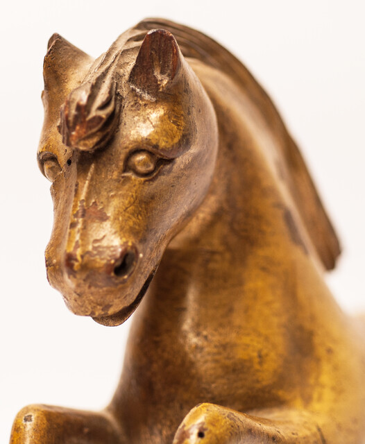 An 18th century Frisian wood carved and gilt rudder decoration in the form of a horse.