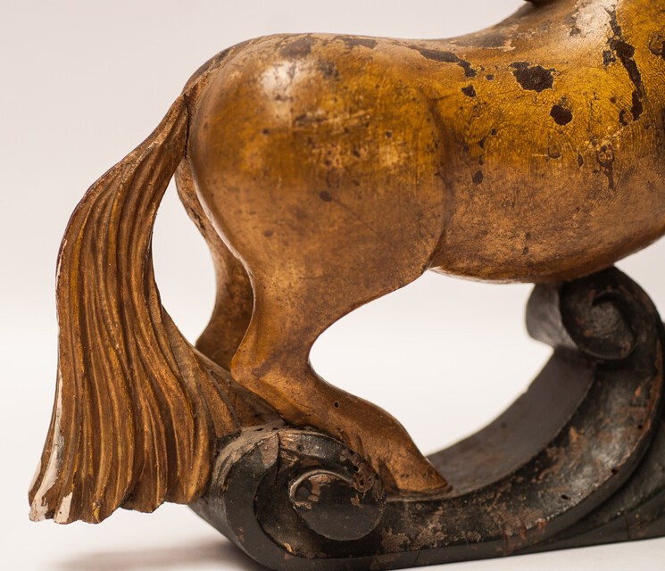 An 18th century Frisian wood carved and gilt rudder decoration in the form of a horse.