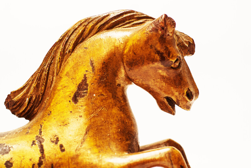 An 18th century Frisian wood carved and gilt rudder decoration in the form of a horse.