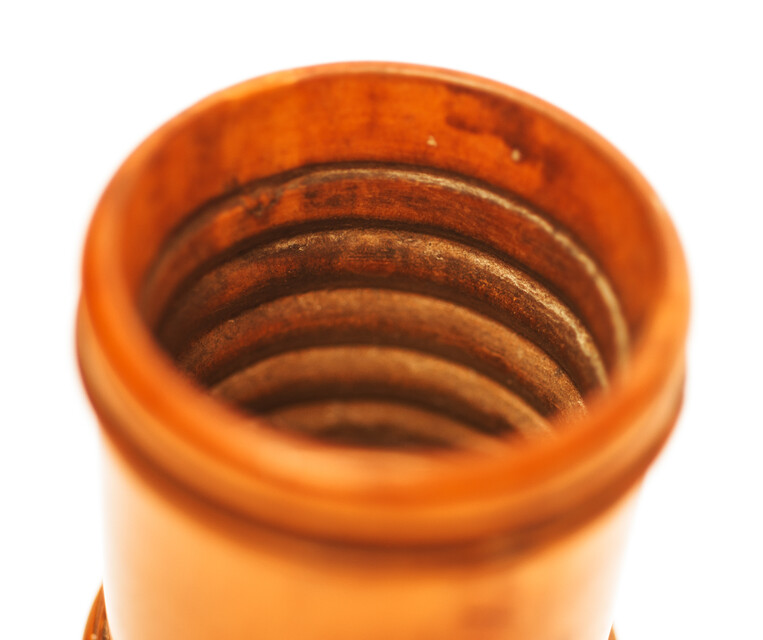 An attractive boxwood dice box with 5 dices.