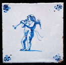 An early 17th C. Delft blue tile with an angel blowing a trumpet.