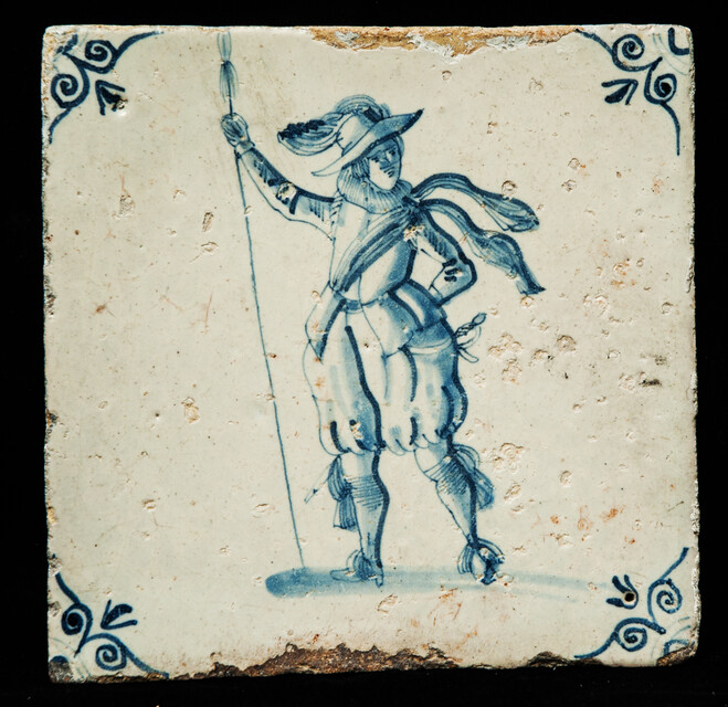 An early 17th C. Delft blue tile with an elegant soldier.