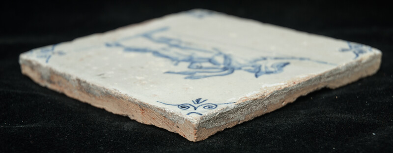 An early 17th C. Delft blue tile with an elegant soldier.