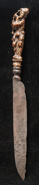 An early 17th Dutch knife with a brass handle showing a bag-pipe player.