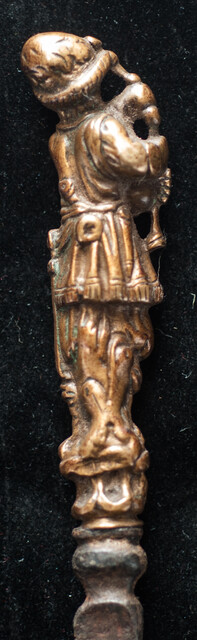 An early 17th Dutch knife with a brass handle showing a bag-pipe player.