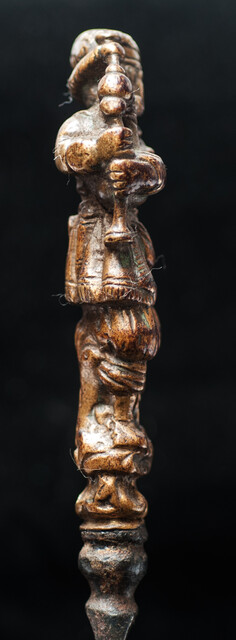 An early 17th Dutch knife with a brass handle showing a bag-pipe player.