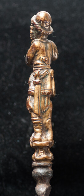 An early 17th Dutch knife with a brass handle showing a bag-pipe player.