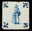 An early seventeenth century Delft blue tile with a nanny and a child.