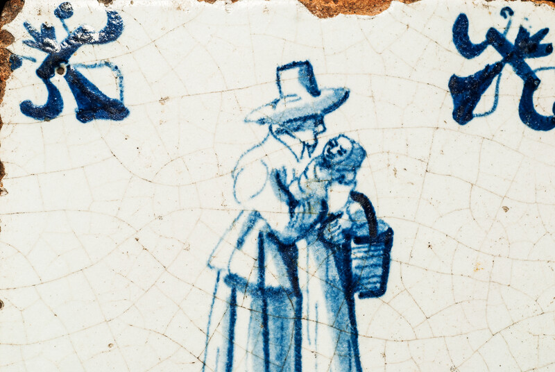 An early seventeenth century Delft blue tile with a nanny and a child.
