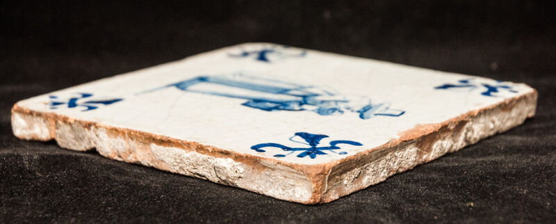 An early seventeenth century Delft blue tile with a nanny and a child.