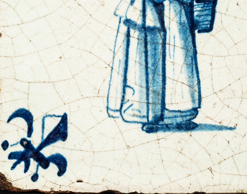 An early seventeenth century Delft blue tile with a nanny and a child.