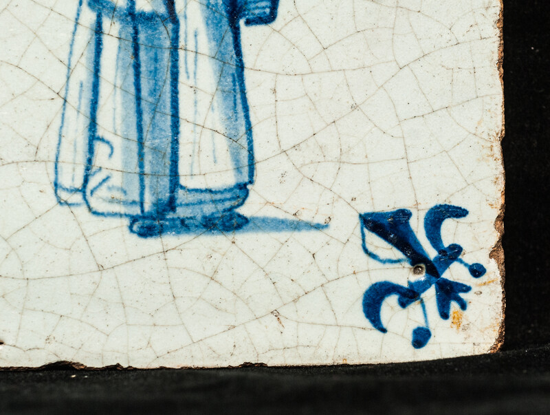 An early seventeenth century Delft blue tile with a nanny and a child.