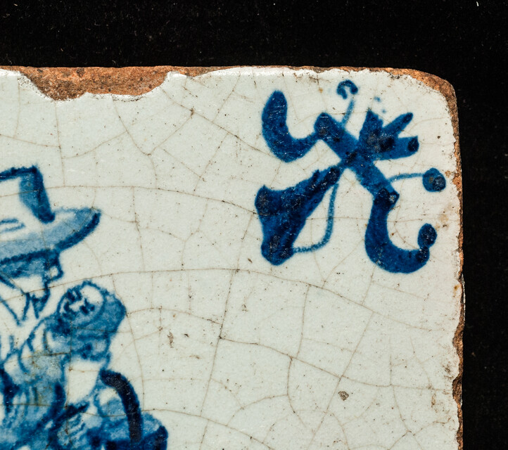 An early seventeenth century Delft blue tile with a nanny and a child.