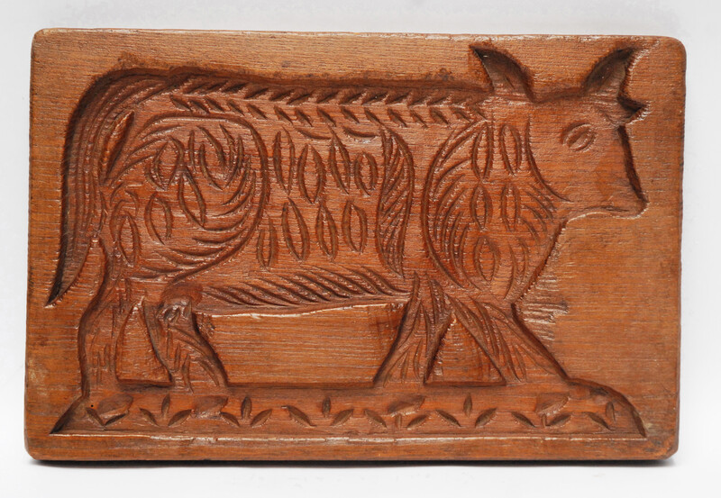 An eighteenth century double sided Dutch cookie mould with a man on a horse and on the other side a cow.