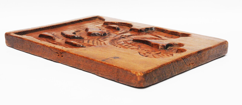 An eighteenth century double sided Dutch cookie mould with a man on a horse and on the other side a cow.