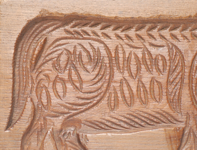 An eighteenth century double sided Dutch cookie mould with a man on a horse and on the other side a cow.